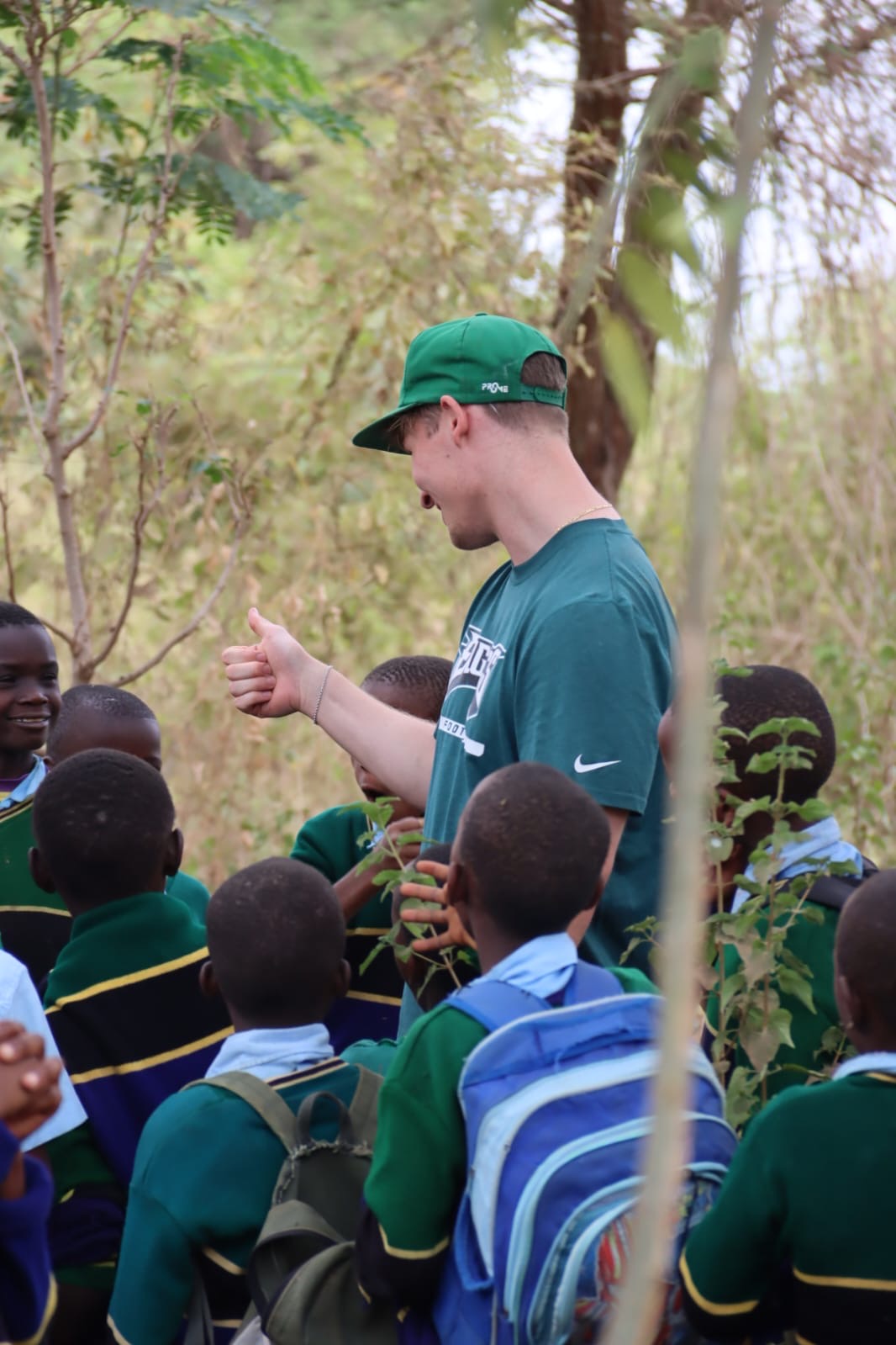 An Enviro Kids educator teaching students among the trees